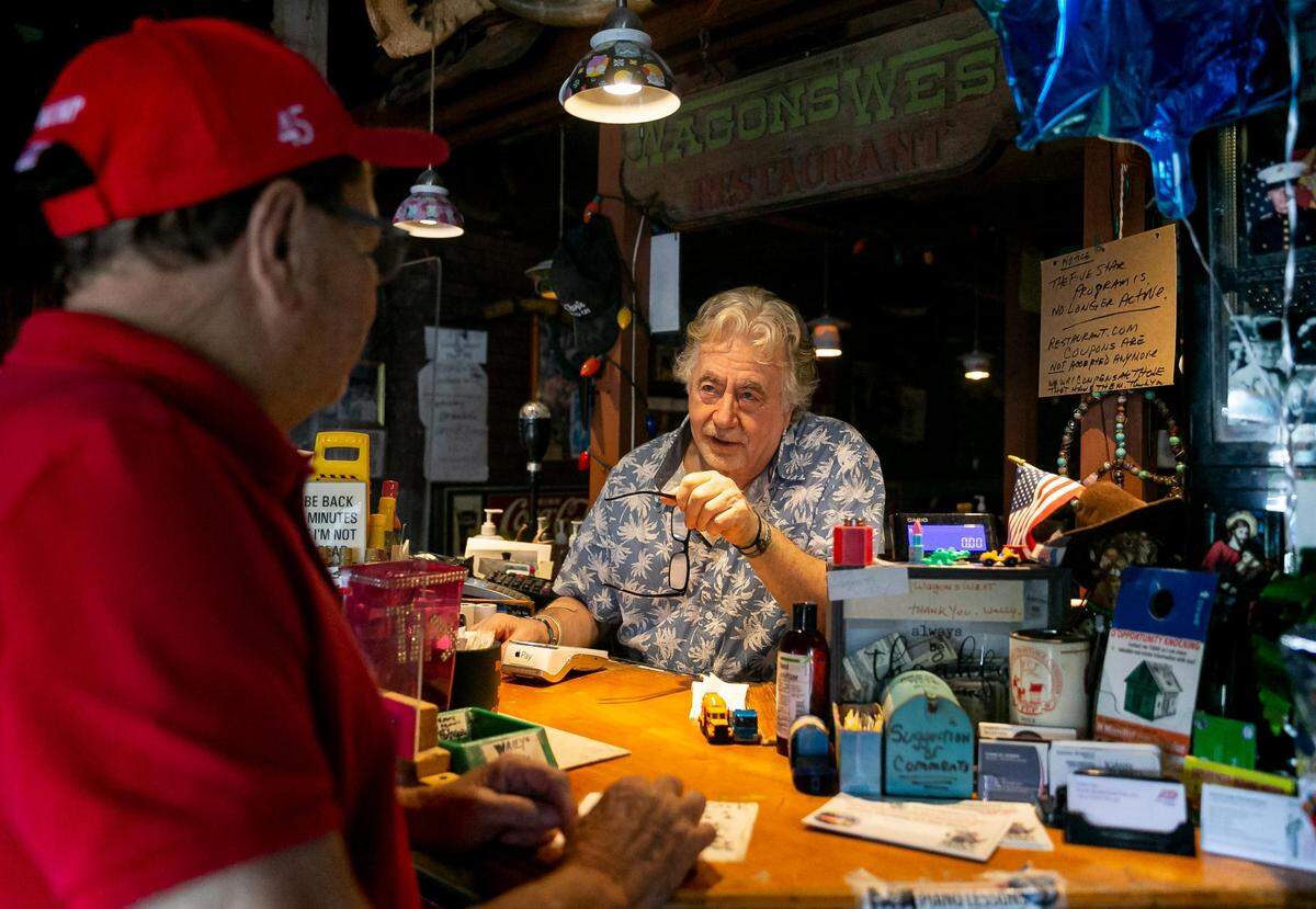 Walter "Wally" Muench, el dueño del restaurante Wagons West, llama a un cliente dentro de su restaurante el viernes 1º de julio de 2022, en Pinecrest.