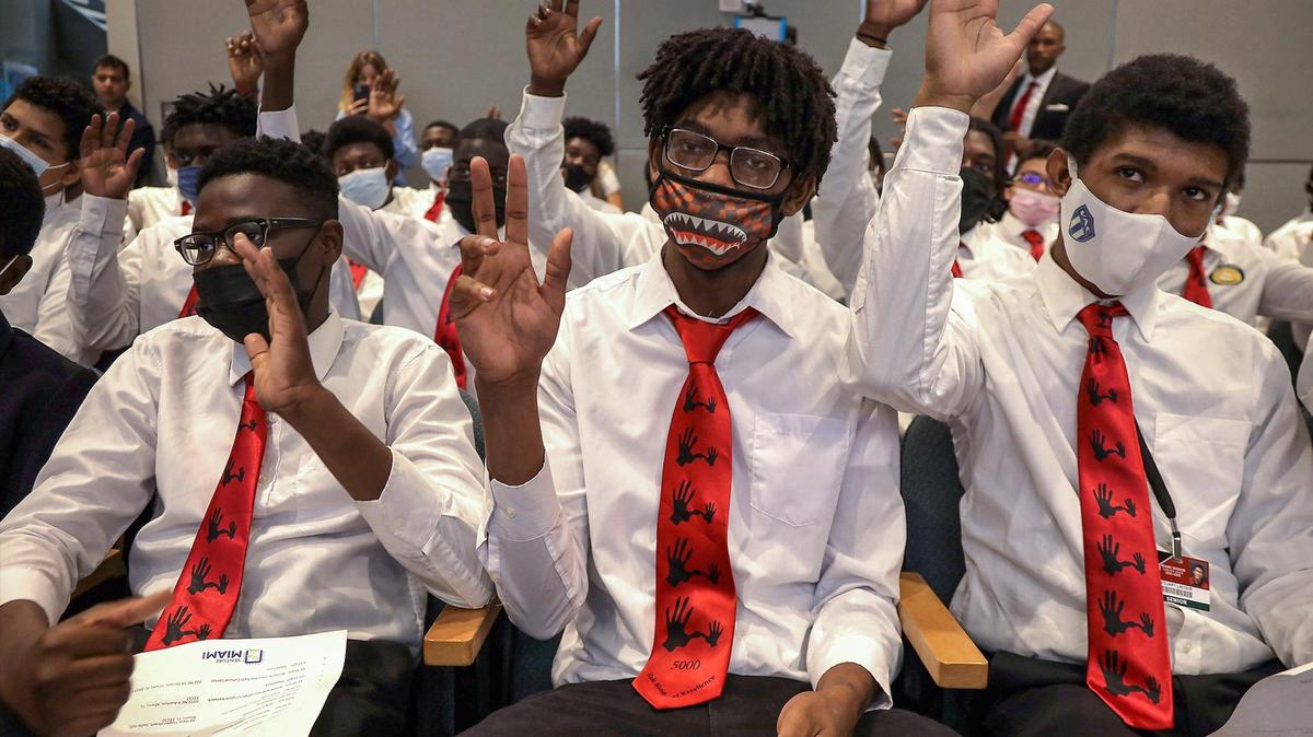 Miami Senior High senior Ricardo-Garaud Laurius, 18, center, joins his peers as Isaiah Jackson gives keynote remarks regarding cryptocurrency. During the 5000 Role Models of Excellence Project Innovation Tour students gathered in Miami City Hall to learn about becoming a part of the growing tech industry in Miami on Wednesday, Oct. 27, 2021.