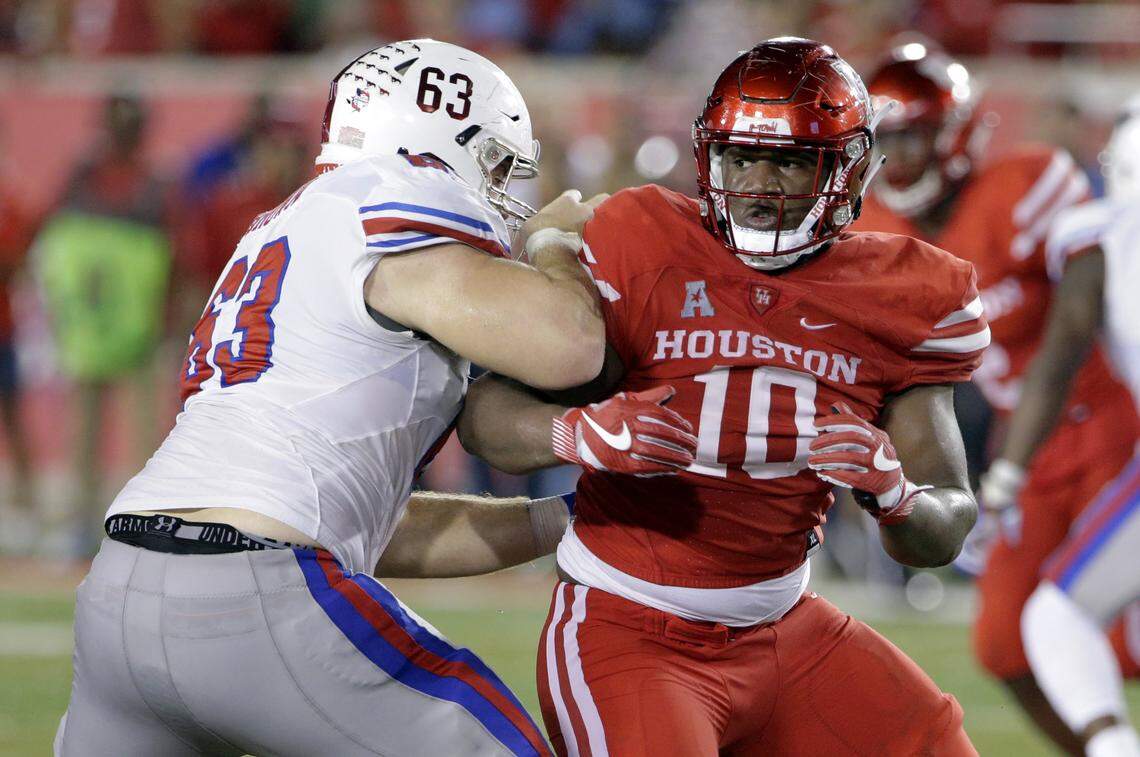 SMU offensive lineman Evan Brown (63) blocks Houston defensive tackle Ed Oliver (10) during an NCAA college football game in Houston.