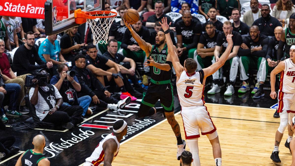 Boston Celtics forward Jayson Tatum (0) lays up the ball while defended by Miami Heat forward Nikola Jovic (5) during the fist half of Game three of an NBA basketball first-round playoff series at Kaseya Center in Miami, Florida, on Saturday, April 27, 2024.