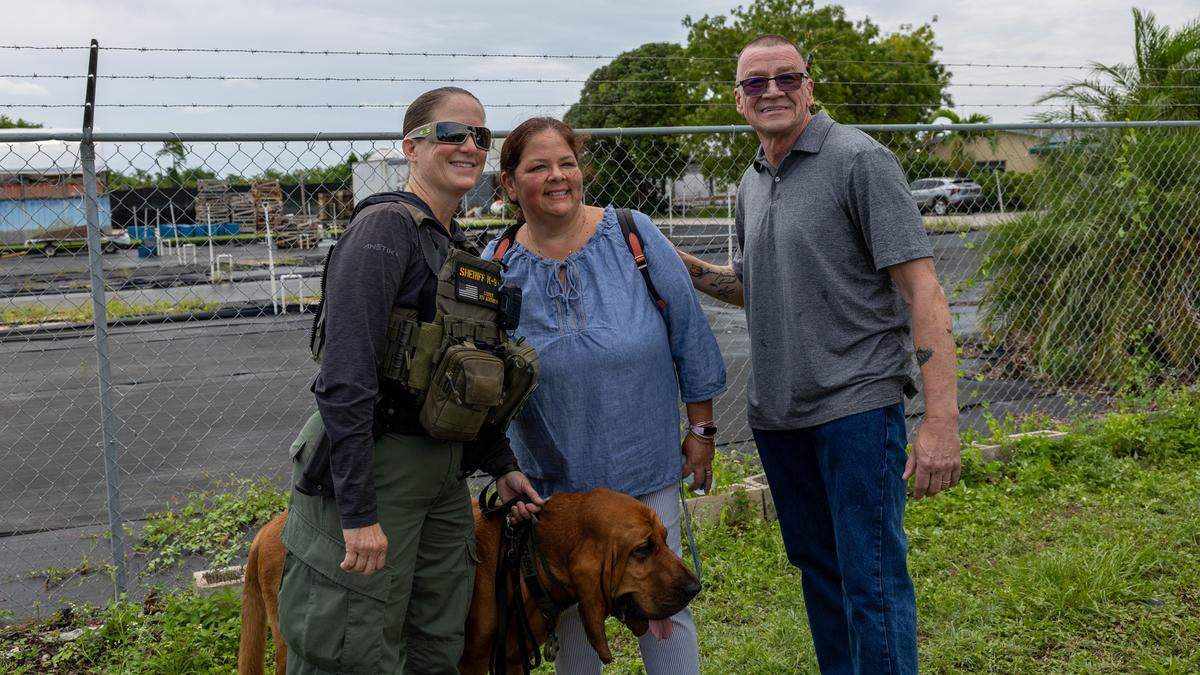 Broward Sheriff’s Office Deputy Kelli Covet and her bloodhound partner Anthem pose with Kathy Montizaan and Ed Montizaanon Jimmy Ryce Avenue at the intersection of Southwest 162nd Avenue and Southwest 232nd Street in he Redland on Friday, June 5, 2026. Kathy and Ed Montizaan have volunteered to maintain the Jimmy Ryce memorial at the intersection.
