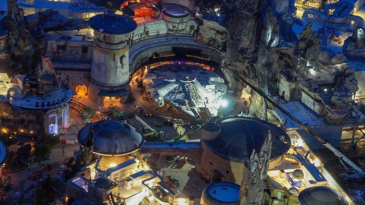 Aerial view of Millennium Falcon at night.