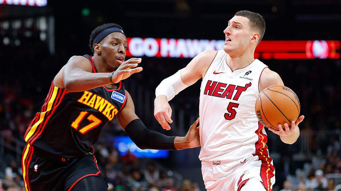 Nikola Jovic #5 of the Miami Heat drives against Onyeka Okongwu #17 of the Atlanta Hawks during the first quarter at State Farm Arena on December 26, 2025 in Atlanta.
