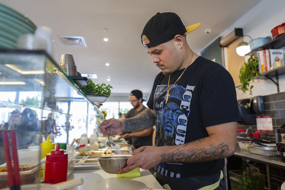 Nando Chang, 30, greets a customer from his pop up Peruvian sushi shop inside the Design District in Miami on Saturday, March 16, 2019. Chang and his sister, Val Chang, have been nominated for a Rising Star James Beard award.