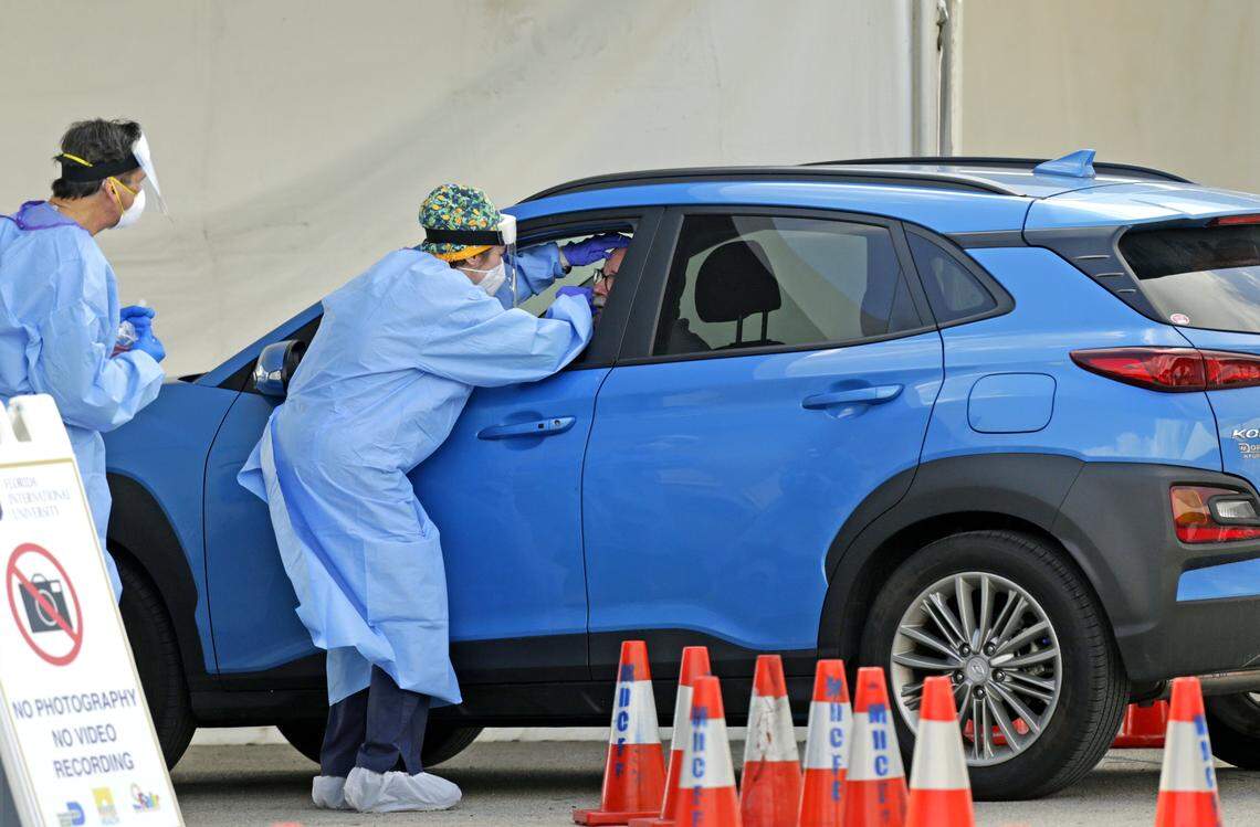 A citizen is being tested by a healthcare worker at the COVID-19 drive-thru testing center at the Tamiami Park as the coronavirus pandemic continues on Wednesday, April 8, 2020 in Miami.