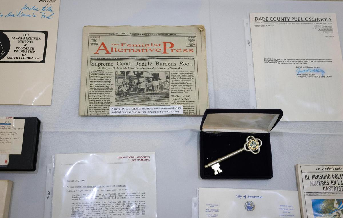A copy of the Feminist Alternative Press that announced the 1992 landmark Supreme Court Decision in Planned Parenthood v. Casey and a Key to the City of Sweetwater sit on display as two of the items from a time capsule buried in 1992, during its unveiling on Wednesday, March 22, 2023, at The Women’s Park in Miami. The time capsule was supposed to be dug up on the 100th anniversary of women’s suffrage, but got delayed due to COVID-19.