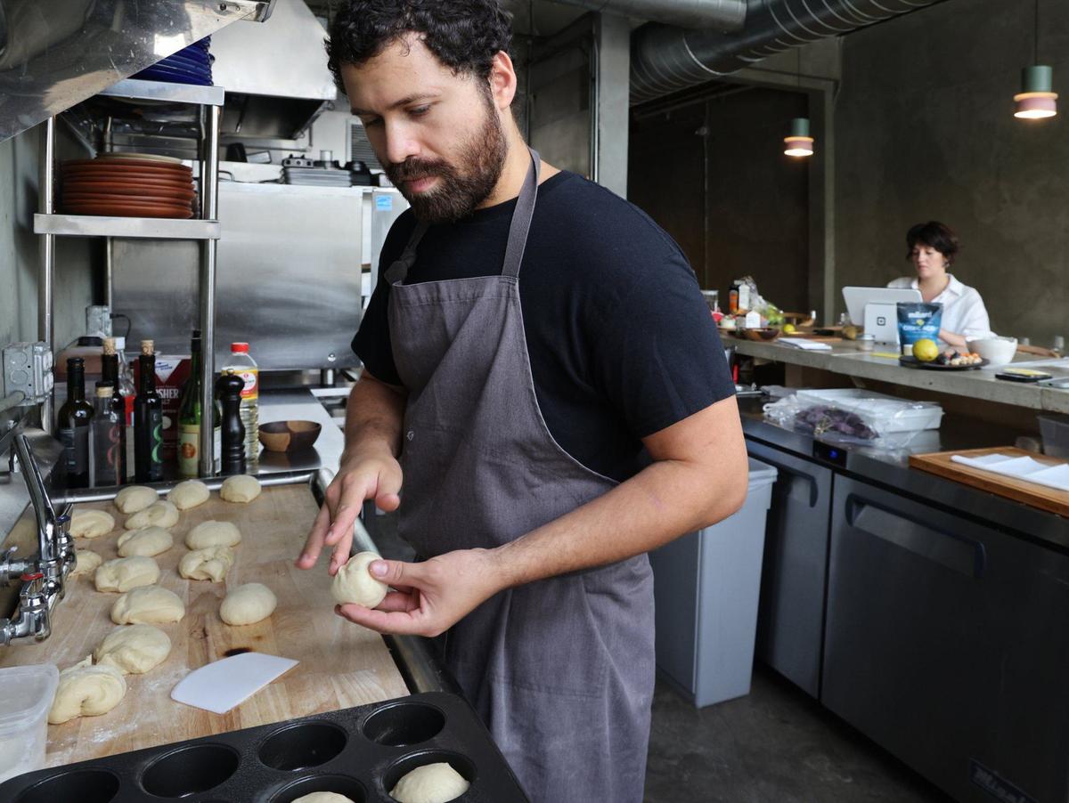 Chef Juan Camilo Liscano prepares the sweet plantain brioche at Palma, a 25-seat restaurant near the Miami River.