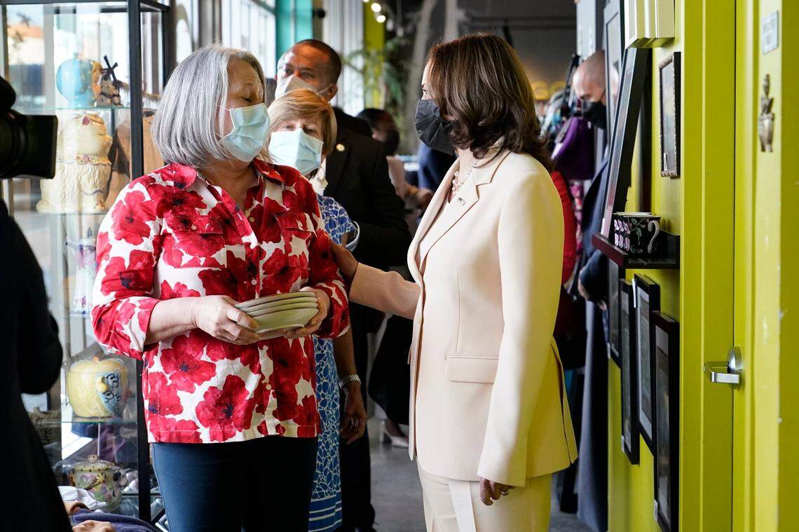Vice President Kamala Harris, right, talks with Nancy Denike, manager of Dragonfly Thrift Boutique, Monday, Aug. 1, 2022, in the Little Havana neighborhood of Miami. Harris stopped by the store while in Miami attending climate resilience events. (AP Photo/Lynne Sladky)