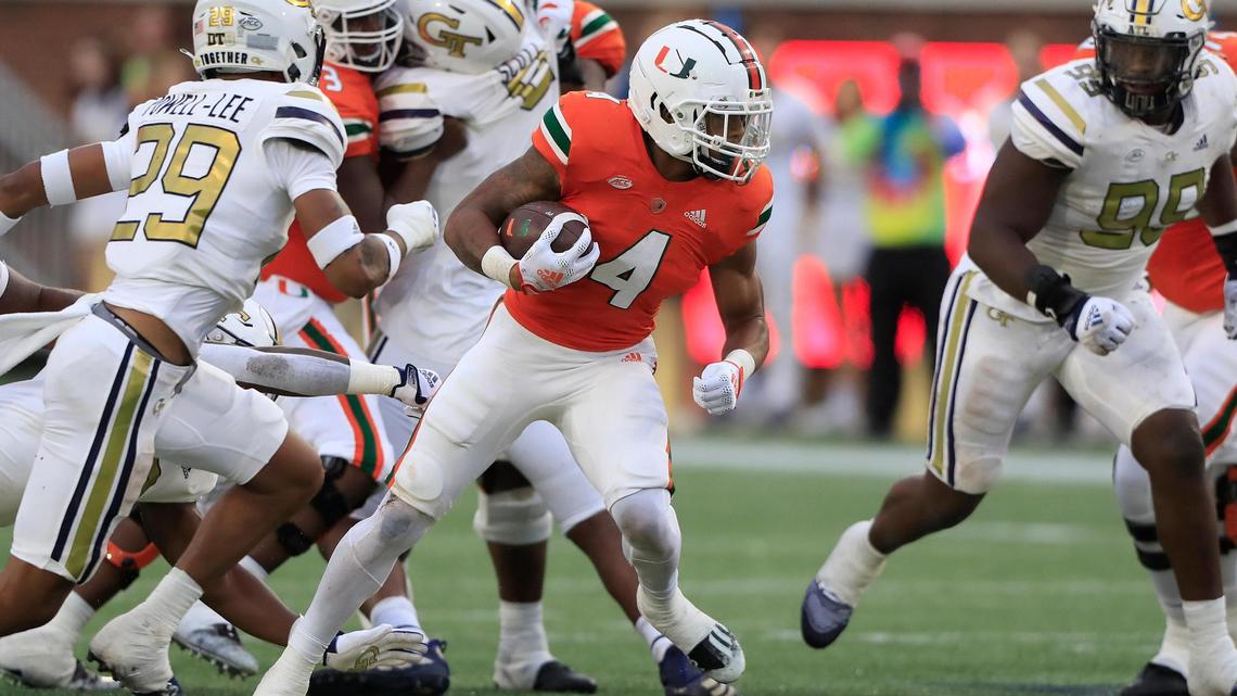 Hurricanes running back Jaylan Knighton carries the football during Saturday’s 35-14 victory over the Yellow Jackets at Bobby Dodd Stadium in Atlanta.