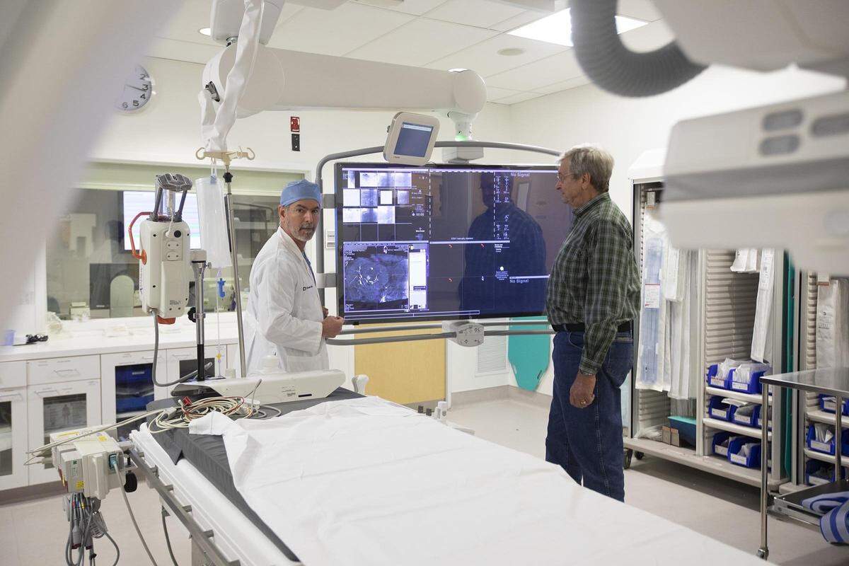 Dr. Kevin Stadtlander, left, and his patient Glenn Dorries are at Cleveland Clinic in Weston on May 3, 2019. Dorries battled liver cancer since 2012 and surpassed the five-year survival mark. He has been treated by Stadtlander.