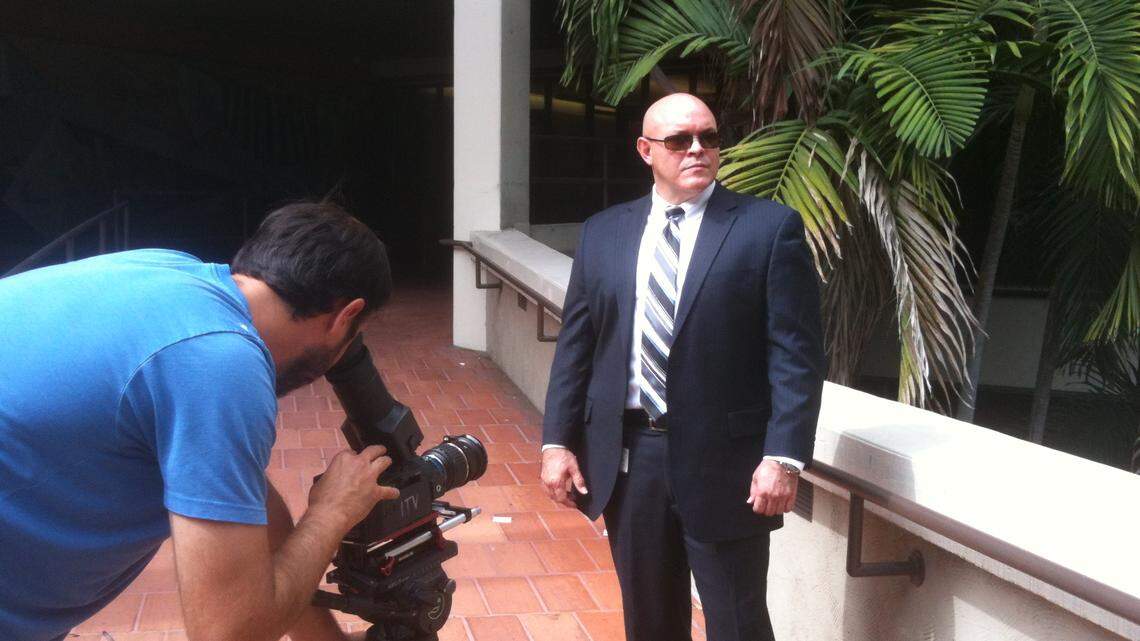 Miami detective Eutemio Cepero being filmed by a cameraman from the cop show “The First 48.”