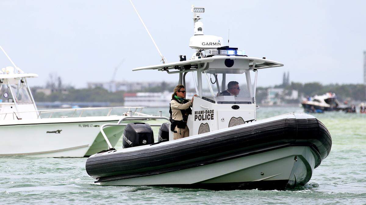 A Miami-Dade Police boat patrols by the Bill Bird Marina at Haulover Park in North Miami during the first day of Memorial Day Weekend, Saturday, May, 23, 2020.
