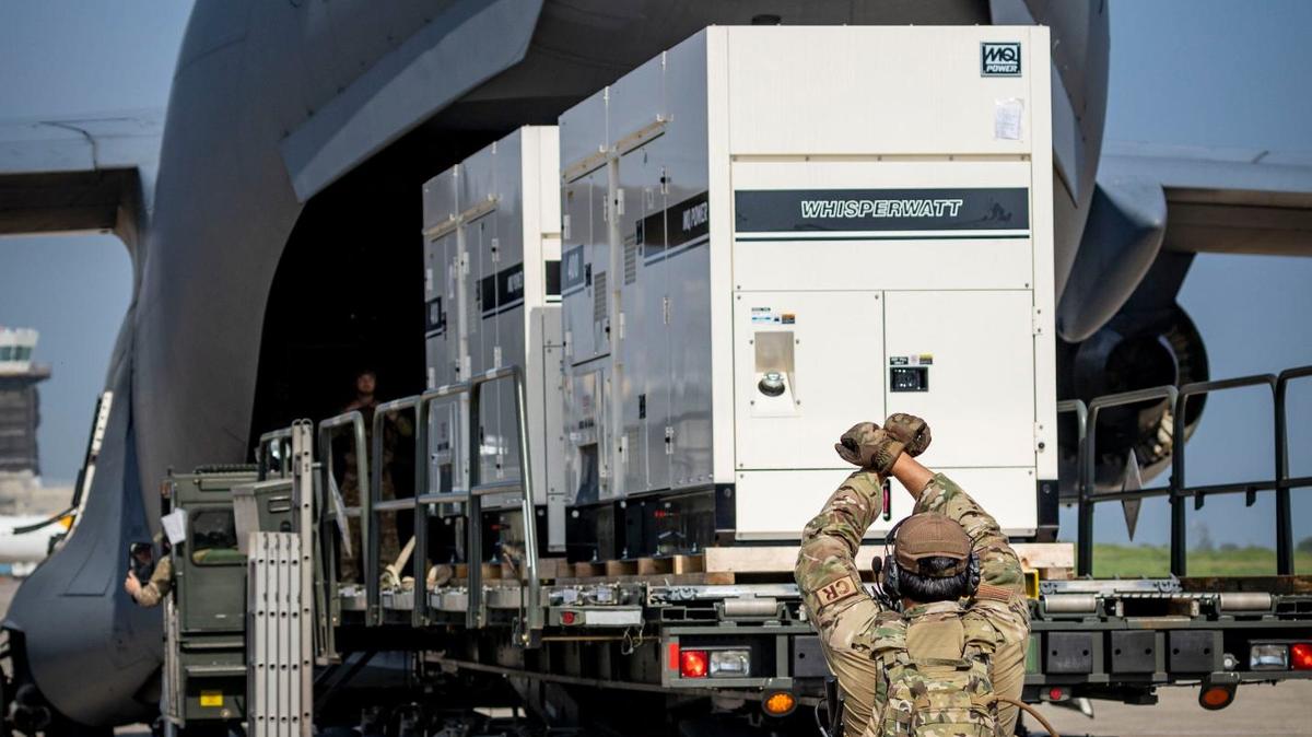 Port-au-Prince, Haiti, May 15, 2024 - A United States serviceman, directs the offloading of supplies from a US Air Force C-17 cargo plane on the tarmac at Toussaint Louverture International Airport in Port-au-Prince, Haiti.