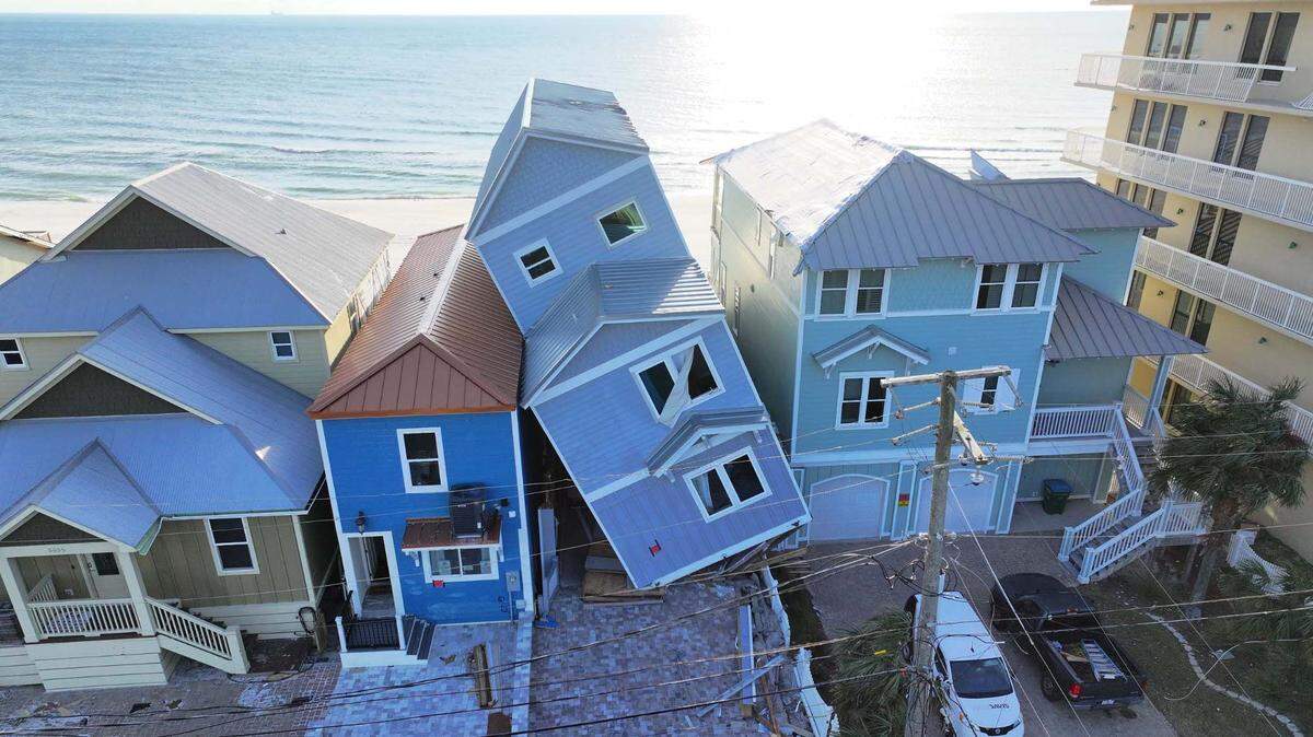 Two neighbors are suing the owners of the leaning home seen in this provided photograph in Panama City Beach, Florida.