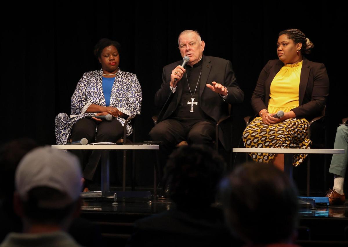 Miami Archbishop Thomas Wenski, center, speaks during a panel about immigration on Thursday, Feb. 23, 2023, at Miami Dade College Wolfson Campus Auditorium.