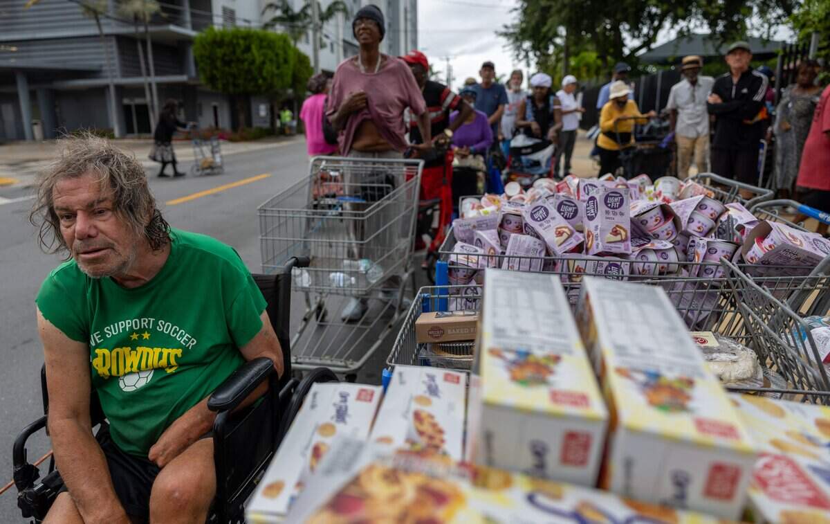 Community members stand in line to receive food at Curley's House Food Bank in Miami on Thursday, June 4, 2026. In front are those with limited mobility, who are served first.