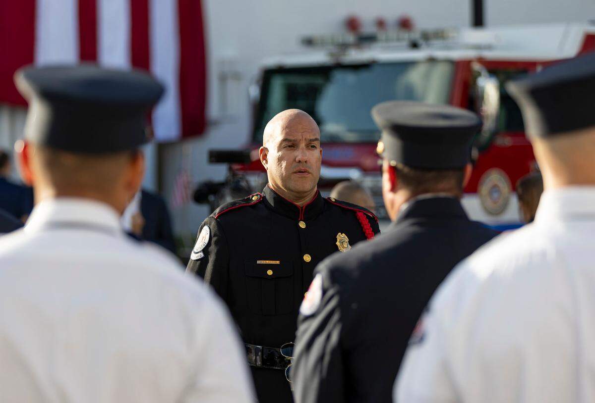 Miami Beach Firefighter and honor guard Jaime Calderon, center, attends a September 11, 2001, remembrance ceremony at Fire Station 2 on Monday, Sept. 11, 2023, in Miami Beach, Fla.