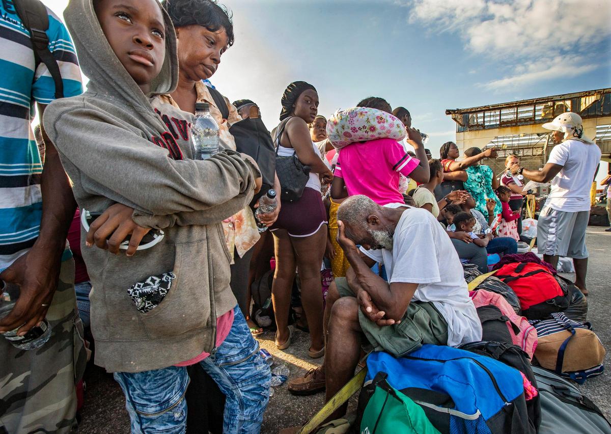 Evacuees wait for transportation to leave Marsh Harbour Port on Abaco Island on Saturday, September 7, 2019.