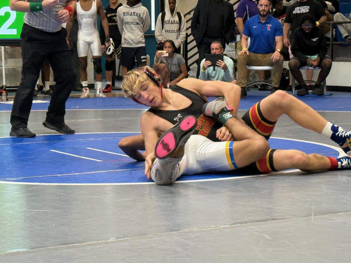 Illia Kyryianenk of South Broward (top) wins BCAA title at 132 pounds on Saturday at Dillard High School in Fort Lauderdale.