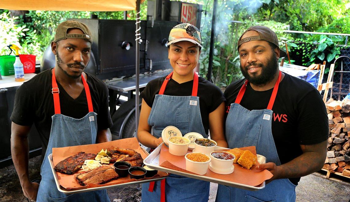 Chef Raheem Sealey, right, his wife, Yohanir Sandoval, and Chef Mark Wint posed at their recently opened pop-up BBQ spot named “Drinking Pig” after deciding that Miami needed more and better barbecue. They are doing this in their off hours, when they aren’t working at KYU, a fine-dining Asian barbecue spot, where Sealey is the head chef and Wint the sous chef as Yohanir works as line cook. They opened the pop-up on the dead-end street in front of Wint’s home in North Miam. They are shown on Friday, Sept. 1, 2020.