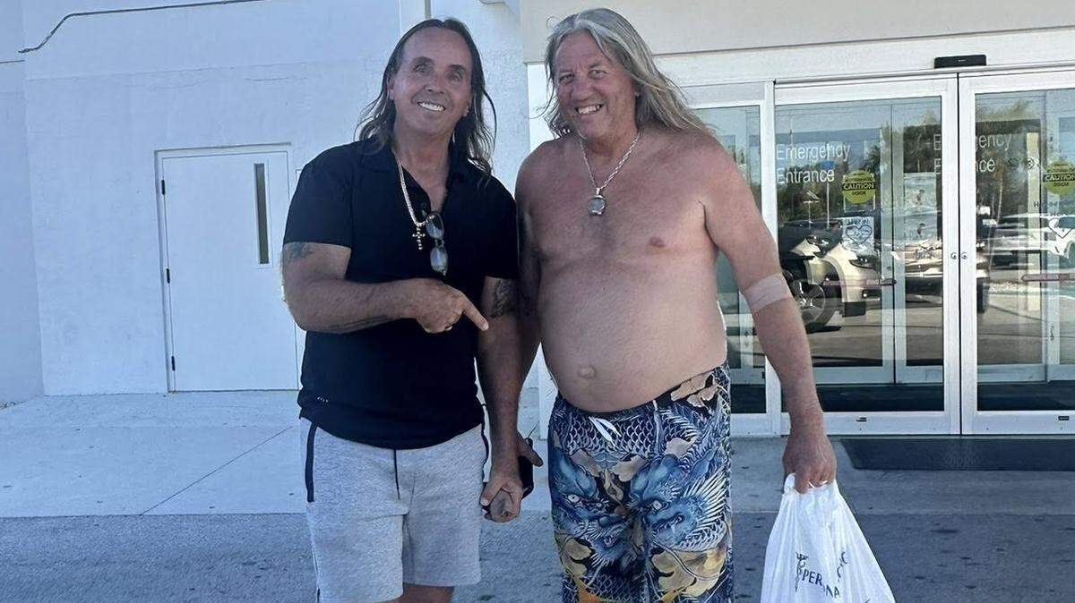 Gary Burchfield, left, owner of Gary the Carpenter in Key West, stands outside of the Lower Keys Medical Center with his employee, Joe Clements, who police say came to the aid of a colleague being attacked with a knife. He was stabbed in the process.