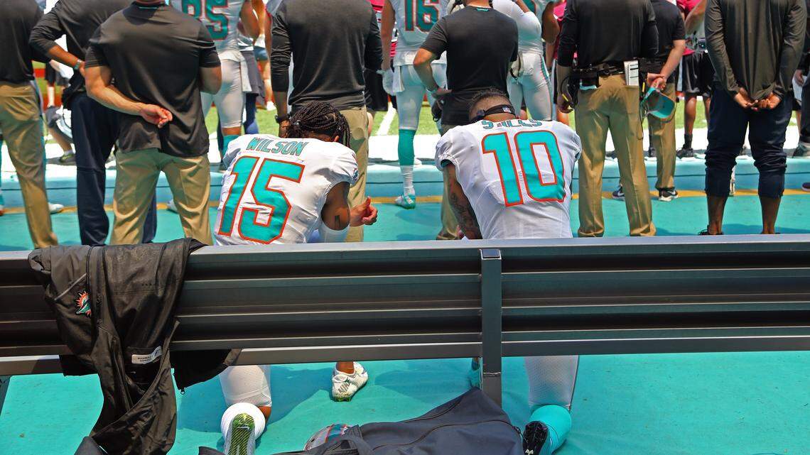 Miami Dolphins wide receiver Albert Wilson (15) and wide receiver Kenny Stills (10) take a knee during national anthem as the Miami Dolphins host the Tennessee Titans at Hard Rock Stadium in Miami Gardens, Florida, on Sunday, September 9, 2018.