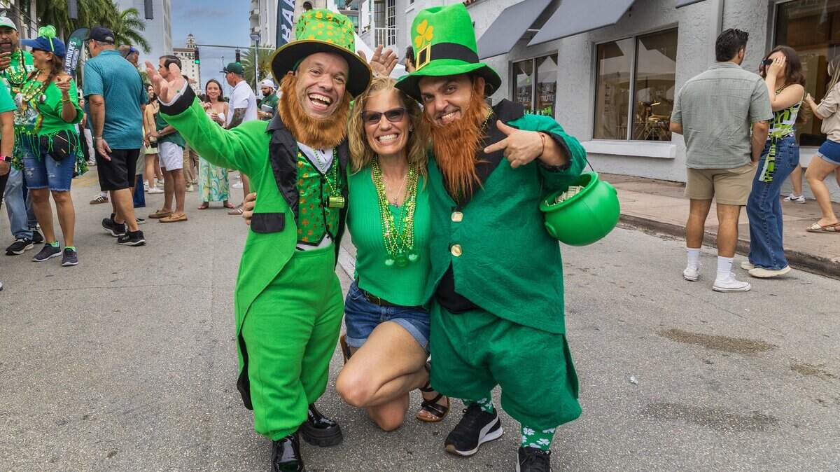 Kirsten Miller posed with performers Juan Espinosa (left) and Elvis Rojas, during the 33rd annual John Martin's St. Patrick's Street Festival in Coral Gables, presented by John Martin's Irish Pub & Restaurant, on Saturday, March 14, 2026.