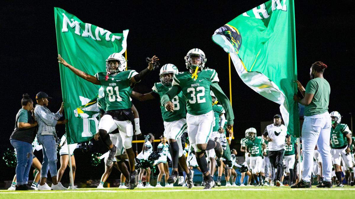 Miami Central players run out onto the field before the first quarter of the 5A high school football semifinals against Glen St. Mary Baker County at Nathaniel Traz Powell Stadium in Miami, Florida, on Friday, December 3, 2021.
