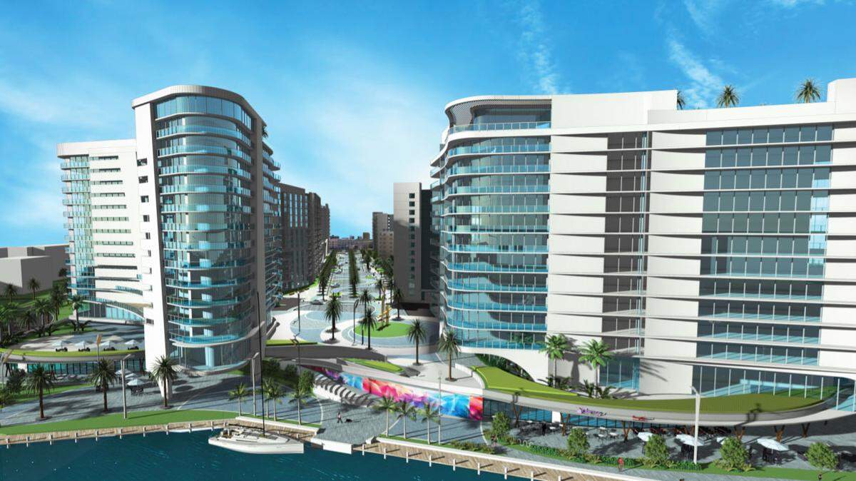 A rendering shows how the River Parc affordable and workforce housing project on the south bank of the Miami River in Little Havana might look when completed. A paseo lined with shops, at center, would connect Northwest Seventh Street with a new riverwalk and public riverfront park.