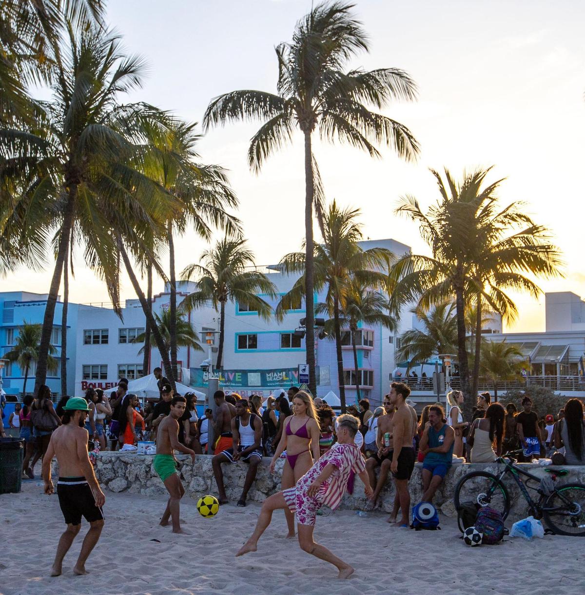 People hangout near Lummus Park during Spring Break in Miami Beach, Florida, on Saturday, March 18, 2023.