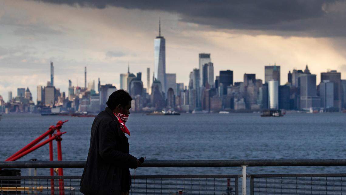 A passenger wearing a mask enters the St. George Ferry Terminal, Tuesday, April 21, 2020, from the Staten Island borough of New York to take the Staten Island Ferry to Manhattan. The city’s Department of Transportation is requiring all Staten Island Ferry passengers to wear a face covering within the ferry terminals and on the boat to curb the spread of the new coronavirus. (AP Photo/Mark Lennihan)