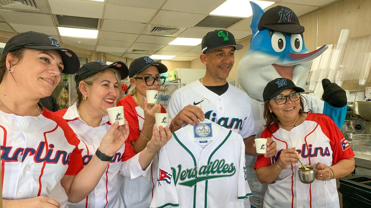 Marlins first base coach Jon Jay poses for a photo with staff at Versailles and Billy the Marlin on Monday, Feb. 6, 2023.