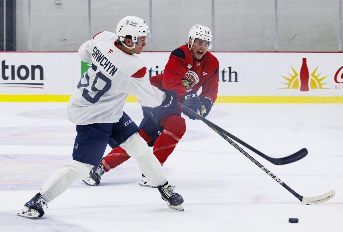 Gracyn Sawchyn (59) hits a puck passed Evan Nause (52) during the first practice of Florida Panthers training camp on Thursday, Sept. 18, 2025, at Baptist Health IcePlex in Fort Lauderdale, Fla. 