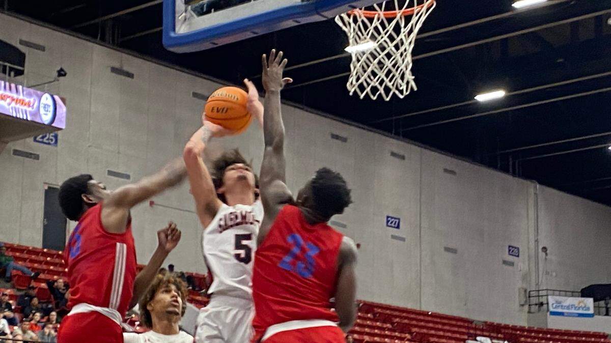 Sagemont guard Tynan Becker challenges two defenders from Jacksonville North Florida Educational Institute on a drive to the basket during Wednesday afternoon’s boys’ basketball Class 2A state semifinal at the RP Funding Center in Lakeland, Fla.