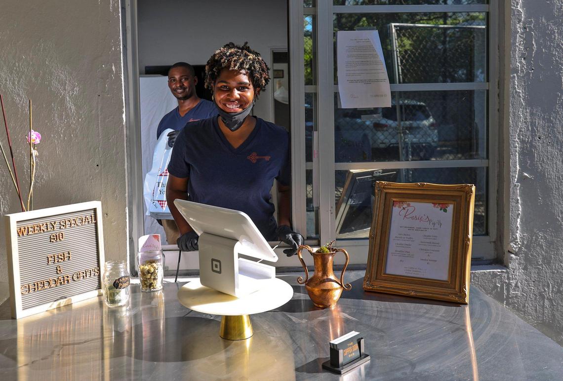 Jamila Ross, front, and Akino West, lowered their masks for this portrait at their 22-room Overtown bed and breakfast, Copper Door, which is closed due to the coronavirus pandemic. The pair have managed to keep themselves and their three employees on the payroll by selling food out of a pop-up, Rosie’s, that they hope to eventually open as a standalone restaurant.