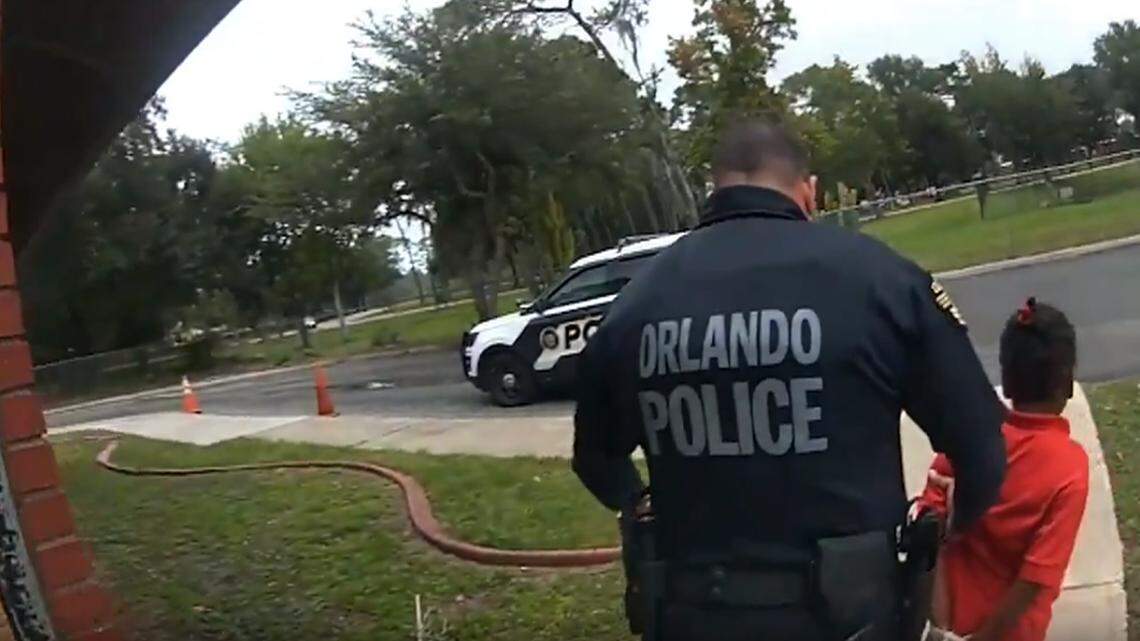 In this image taken from Sept. 19, 2019, Orlando Police Department body camera video footage, Orlando Police Officer Dennis Turner leads 6-year-old Kaia Rolle away after her arrest for kicking and punching staff members at the Lucious & Emma Nixon Academy Charter School in Orlando, Florida.