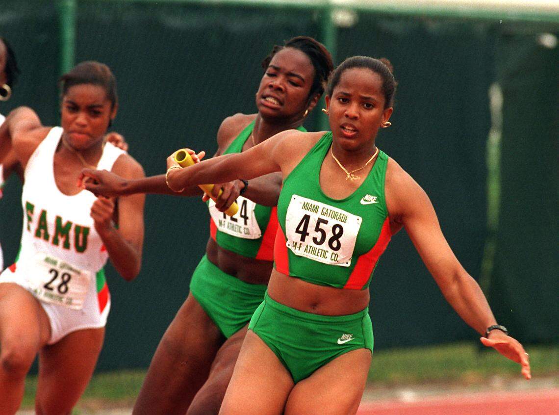 TRACK MEET CHARLES TRAINOR JR 4/1/95 UM’s Gillian Russell takes the baton from Patrina Allen during the 4x100 meter relay. The UM placed first in the race.