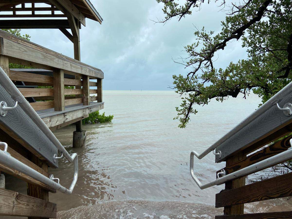 Water from the ocean flows over the sand to the steps of the boardwalk at Anne’s Beach in Islamorada Sunday, Nov. 8, 2020.