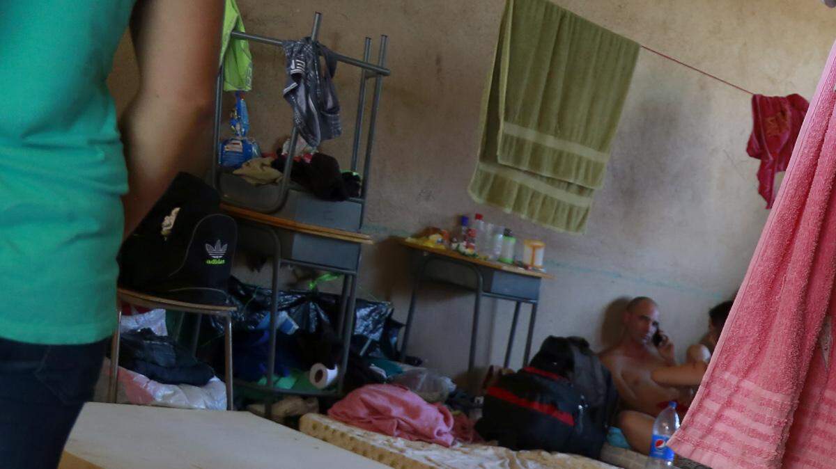 Cuban migrants relax at a temporary shelter in La Cruz, Costa Rica, Tuesday, Jan. 12, 2016. 