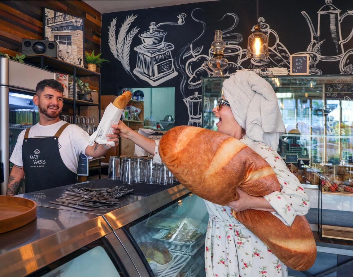 Emanuel Mondes at We We’s Cafe passes Anna Zilberberg a baguette that’s almost as soft and luscious as her Bread Pillow.