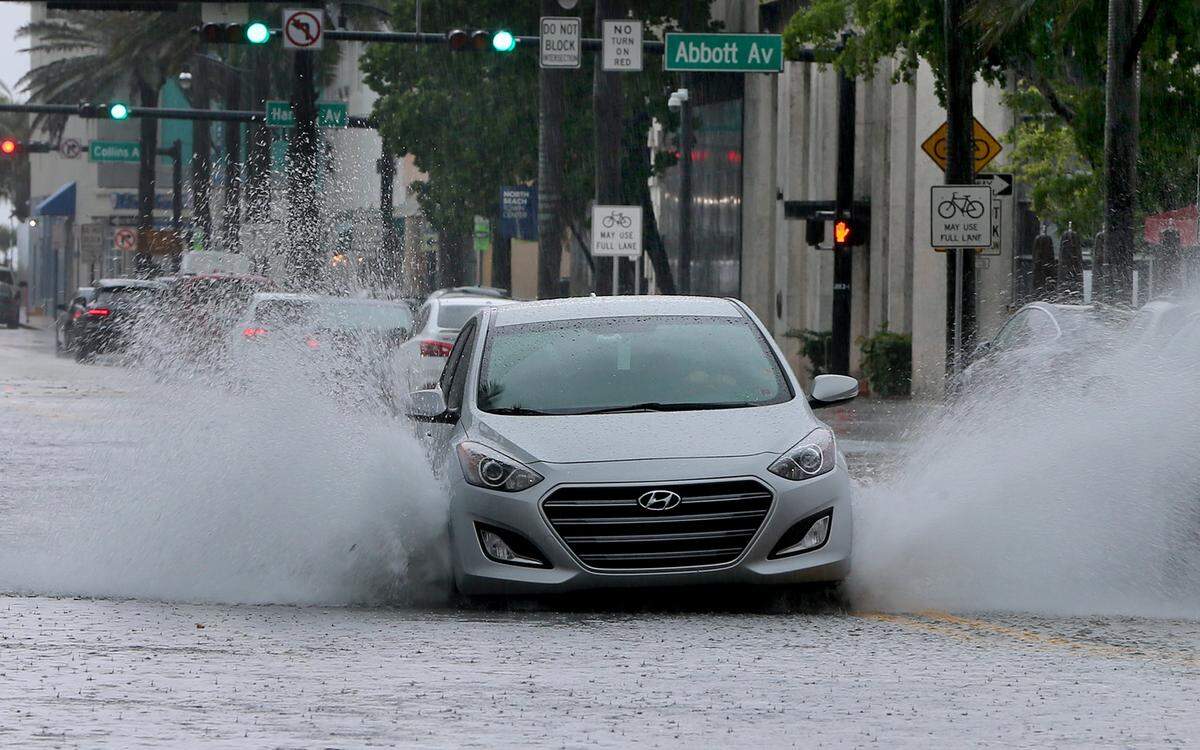 In this file photo, cars drive through flood waters on 71st Avenue in Miami Beach during a tropical disturbance on Memorial Day Weekend on Monday, May 25, 2020. Could the same happen the weekend after the 2022 Memorial Day holiday? Heavy rains, associated with a disturbance, are forecast for Miami-Dade, Broward, Palm Beach and the Keys on June 3-4, 2022.