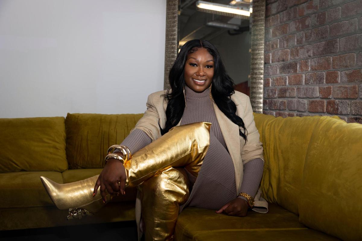 Keya Martin, Keeyahri founder and designer, poses in her workspace while wearing the Zerina thigh high boot on Wednesday, Feb. 7, 2024, in Miramar. Martin runs the business on her own. The Zerina boots are named after Beyoncé’s stylist. “All of my boots are named after people who inspire me,” said Martin. The signature heel to all of her luxury shoes was inspired by a Japanese wedding chapel.