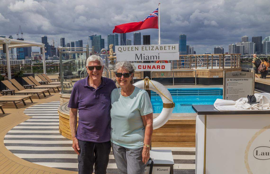 Passengers Jenny and Robert Beard of Australia posed on the Cunard cruise ship Queen Elizabeth's pool deck as the ship is docked at PortMiami on Thursday, Oct. 16, 2025, in Miami. The vessel arrived around 6 a.m. and will be based in Miami for six months, offering voyages to the Caribbean. After tours and festivities, the ship is scheduled to depart later Thursday on its inaugural 12-night Caribbean cruise.