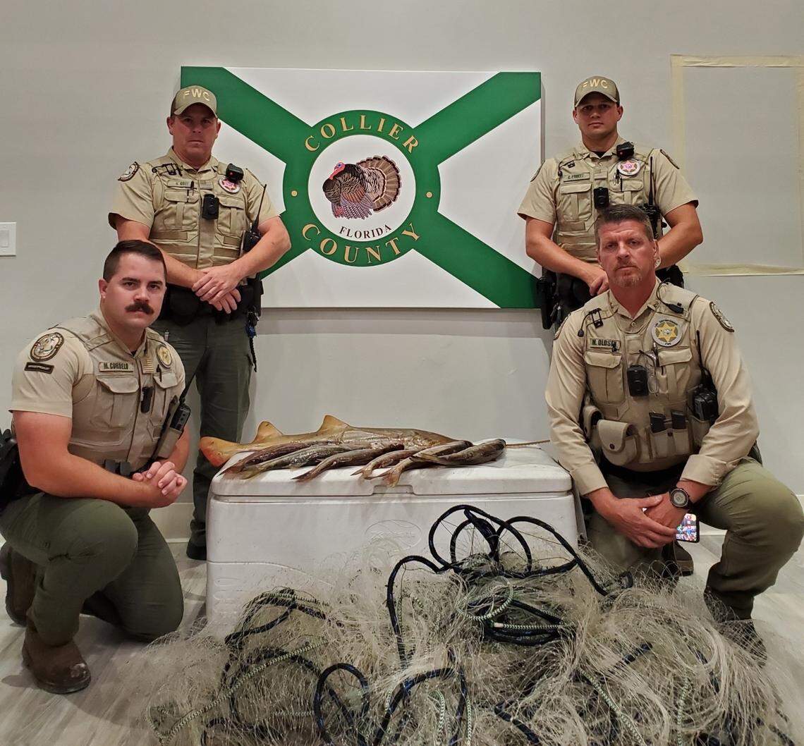 Florida Fish and Wildlife Conservation Commission officers pose with a gillnet they confiscated Saturday, Oct. 22, 2022, in Collier County. Two men were arrested in connection to the case in which multiple fish were killed, including an endangered smalltooth sawfish.