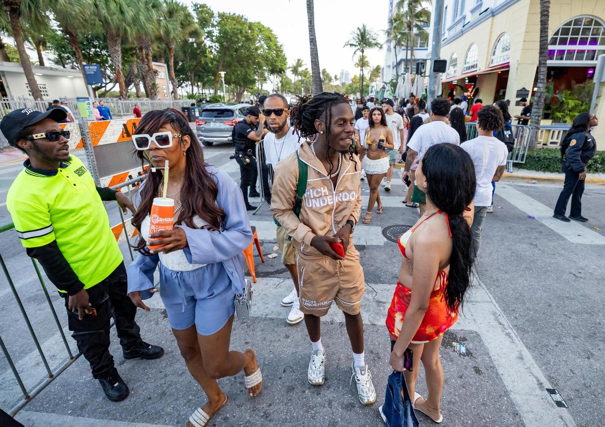 People make their way down Ocean Drive near 10th Street during spring break on Saturday, March 15, 2025, in Miami Beach, Fla.