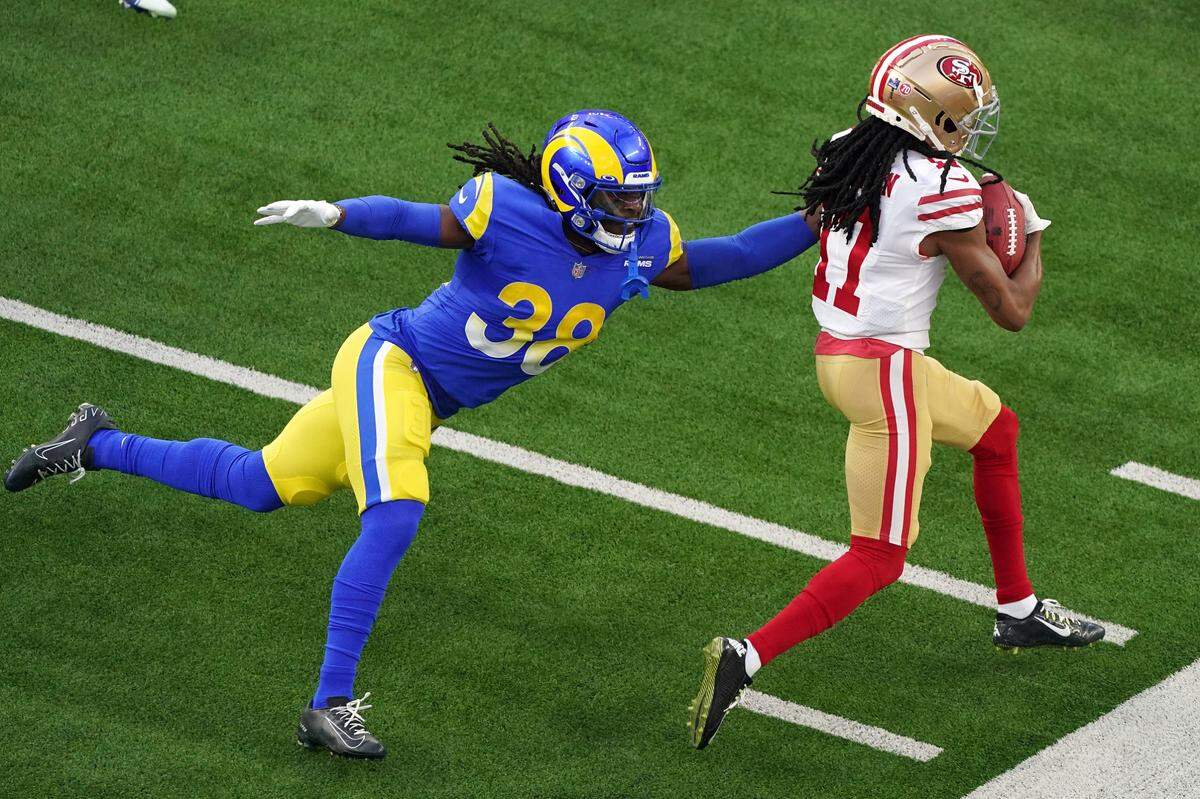 Los Angeles Rams’ Buddy Howell (38) tries to bring down San Francisco 49ers wide receiver Travis Benjamin (17) during the NFL NFC Championship game, Sunday, Jan. 30, 2022 in Inglewood, Calif. The Rams defeated the 49ers 20-17.