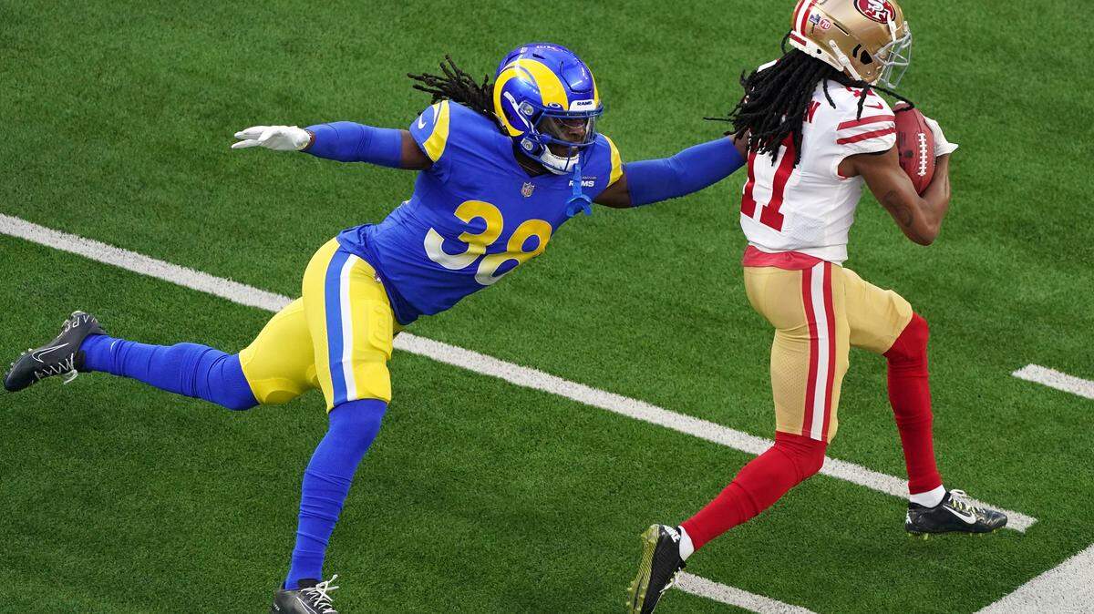 Los Angeles Rams’ Buddy Howell (38) tries to bring down San Francisco 49ers wide receiver Travis Benjamin (17) during the NFL NFC Championship game, Sunday, Jan. 30, 2022 in Inglewood, Calif. The Rams defeated the 49ers 20-17.