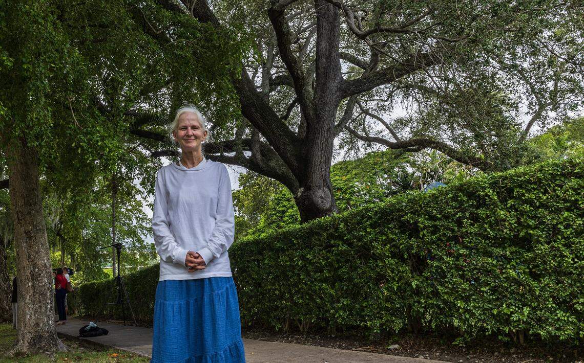 Resident Bonnie Bolton stands in the side walk by a centenary Oak tree situated  inside the Crystal Academy, in the site that  also is home of the St. James Evangelical Lutheran Church of Coral Gables and was bought by the Century Homebuilders Group in 2021 with plans to removes all trees and buildings to develop a project called Crystal, a 9-story mixed-use building,  on Thursday, August 07, 2025.