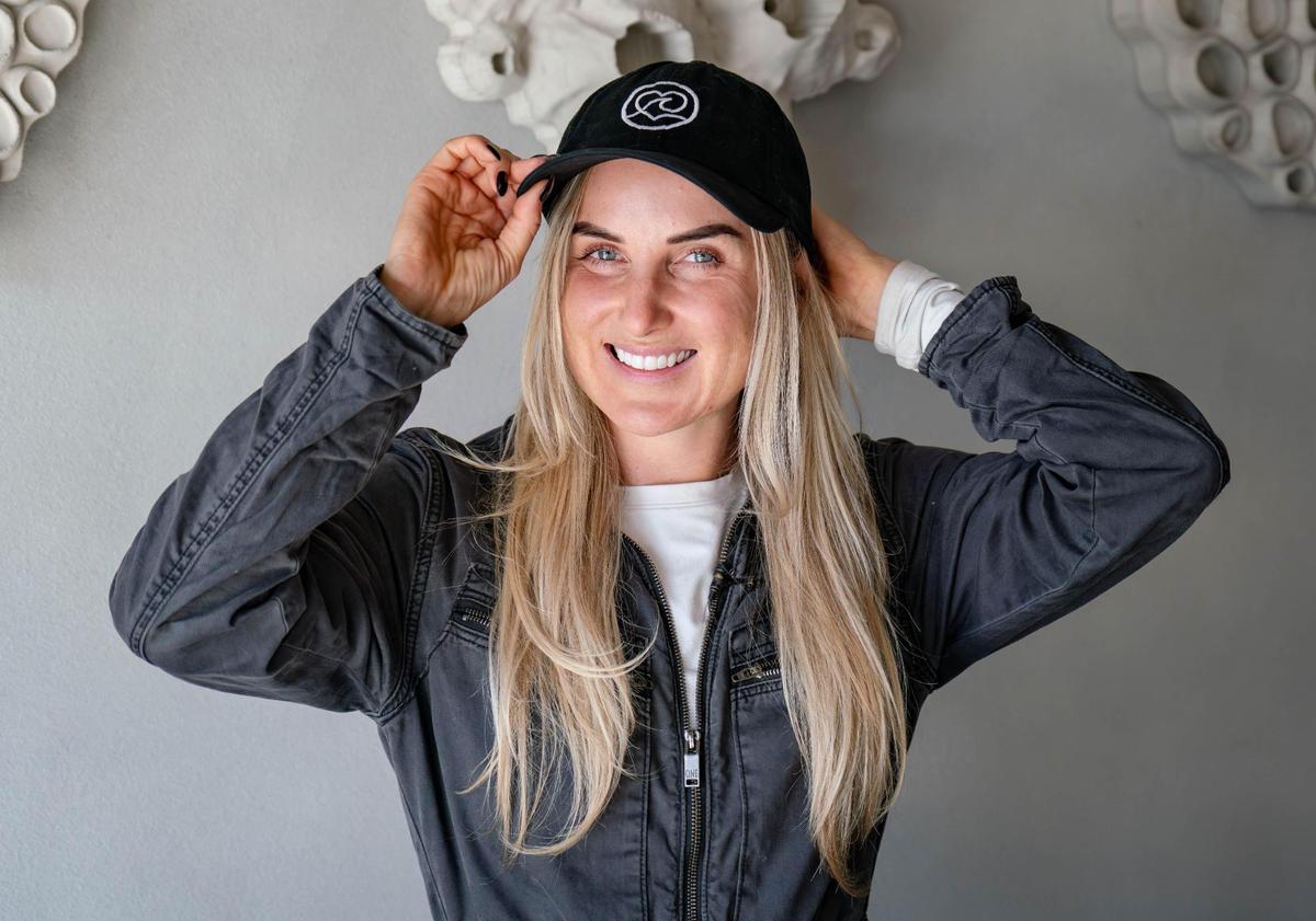 Founder and CEO of Kind Designs Anya Freeman shows off her company baseball cap at their headquarters in Miami