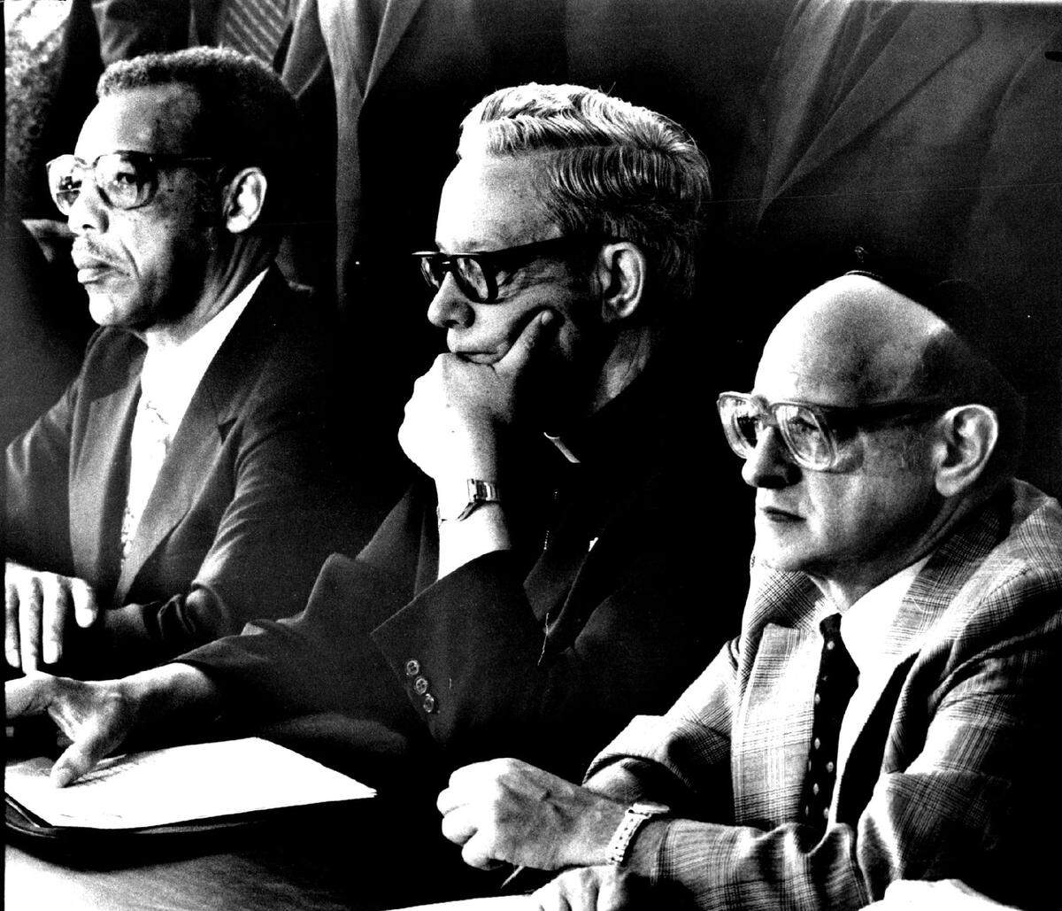 Press conference on Oct. 16, 1981, with Miami’s religious leaders, who will send an open letter to President Reagan concerning the grave conditions at the Krome Avenue camp for Haitian refugees. From left are Rev. Irvine Elligan, Archbishop Edward A. McCarthy and Rabbi Solomon Schiff.